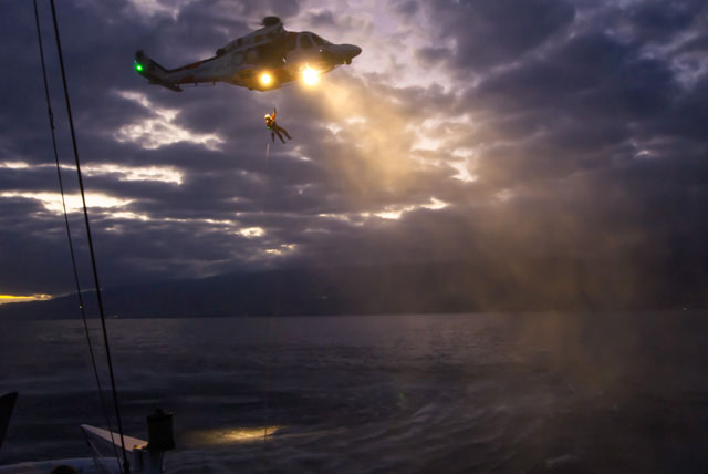 rescatador bajando al mar desde helicóptero
