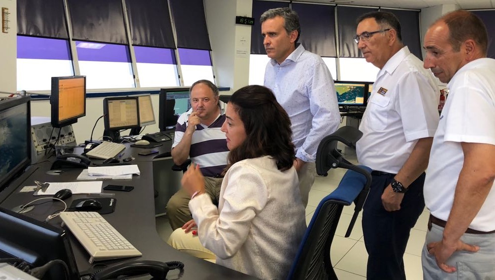 cinco controladores mirando a una pantalla en el centro de coordinación